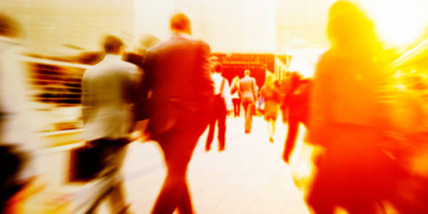 Professionally dress people walking quickly through a lobby